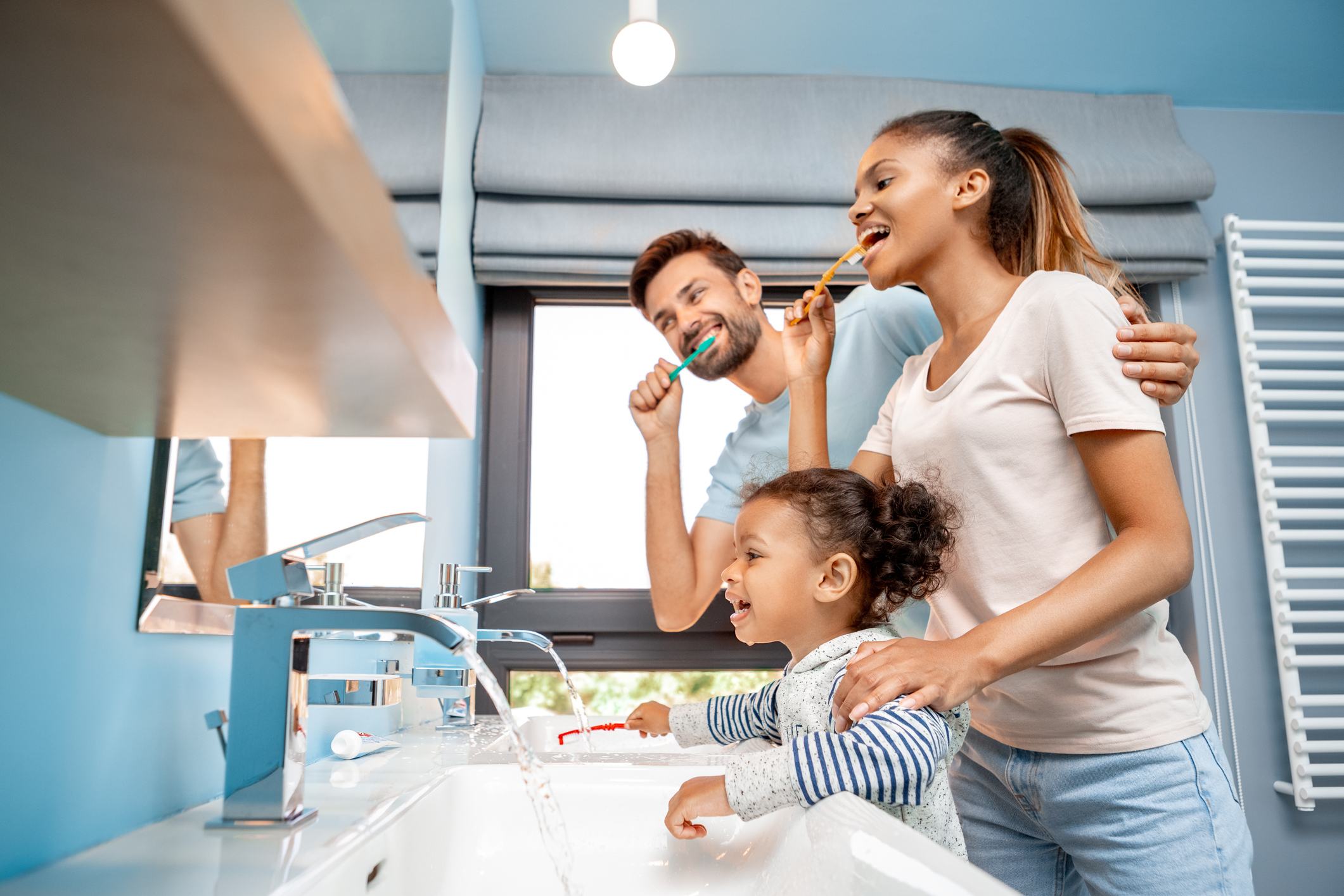 Family brushing their teeth together